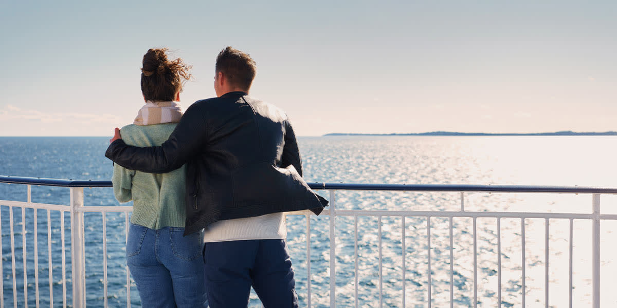 Couple on deck with breeze Promo
