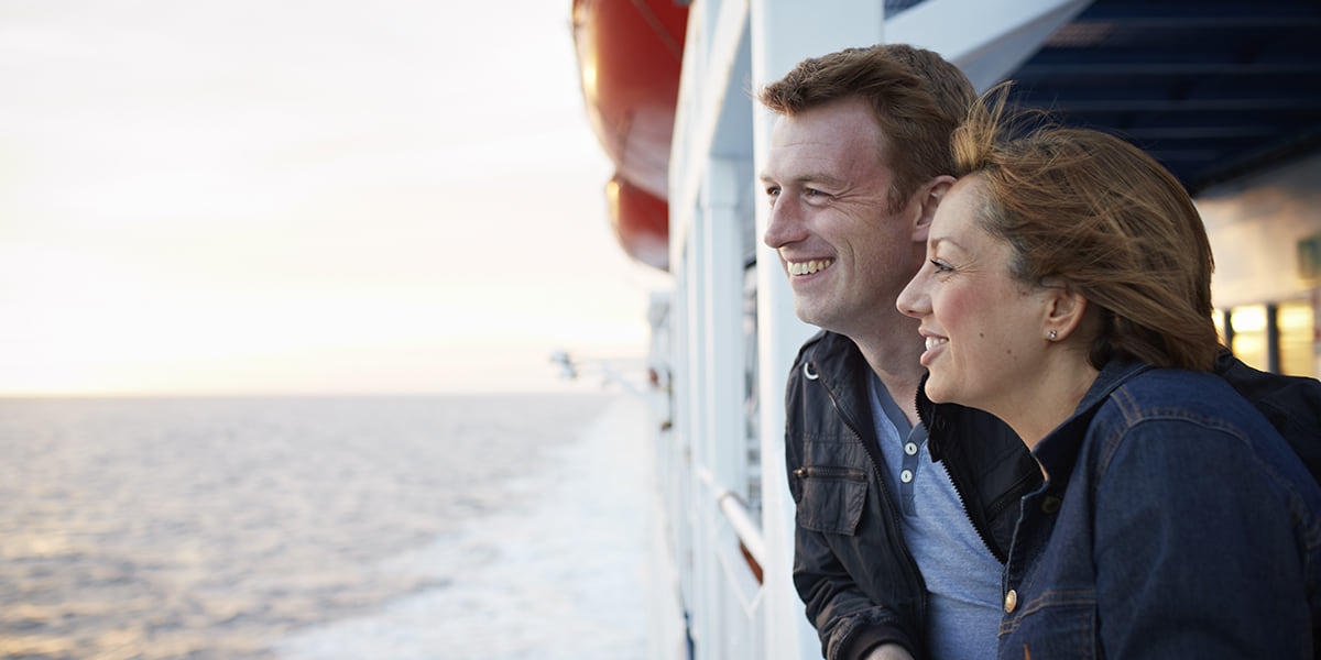 Couple smiling on deck during a ferry crossing Ferry Crossing England Couple on deck