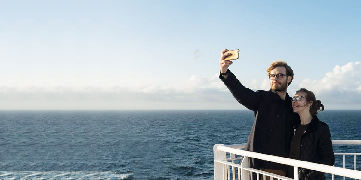 Couple on deck taking selfie Couple on deck taking selfie